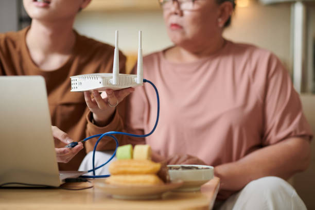 Tech expert connecting two routers wirelessly to boost Wi-Fi signal coverage