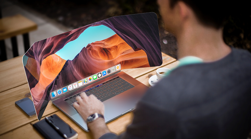 A man uses a laptop with a futuristic, flexible display at an outdoor café, illustrating advanced screen technology.