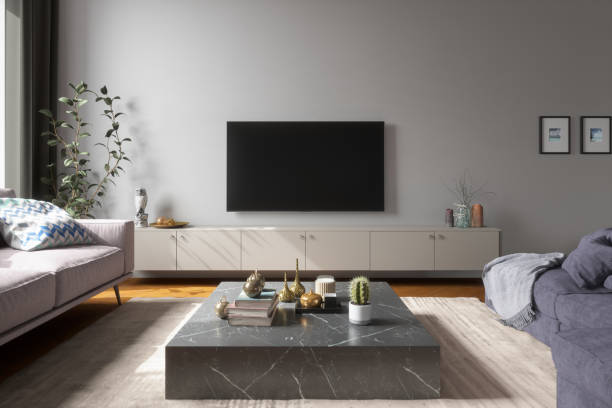 A modern living room with an 8K flat-screen TV mounted on the wall above a sleek entertainment console.